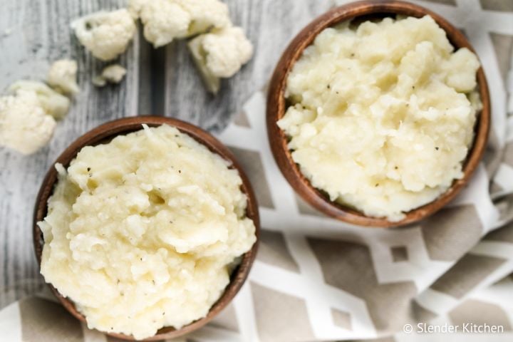 Mashed cauliflower served in two small wooden bowls.