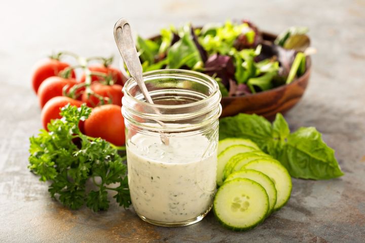 Skinny ranch dressing in a glass mason jar with vegetables.