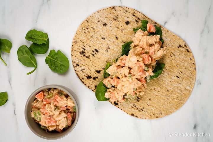 Buffalo ranch chicken wrap with celery, carrots, buffalo dressing, and ranch seasoning in a wrap with spinach.