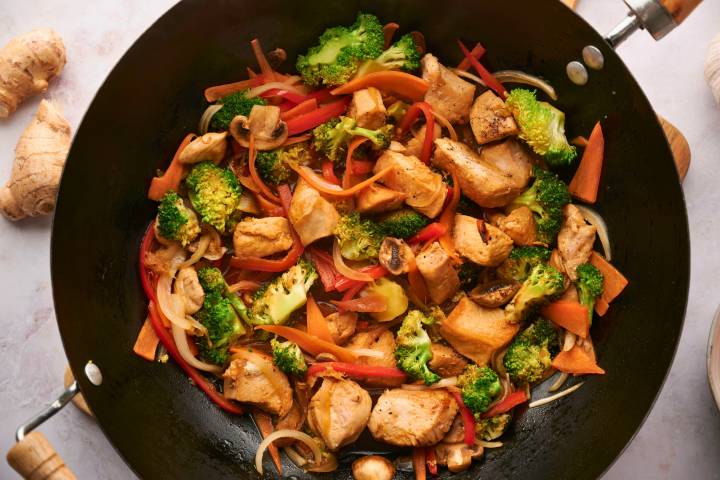 Chicken stir fry with chicken breast, broccoli, carrots, bell peppers, and onions in a homemade stir fry sauce.