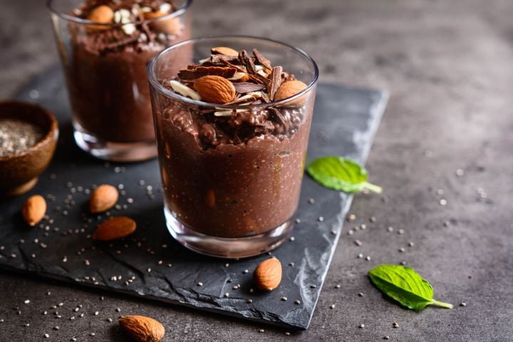Chocolate chia seed pudding in a glass with a sprig of mint.