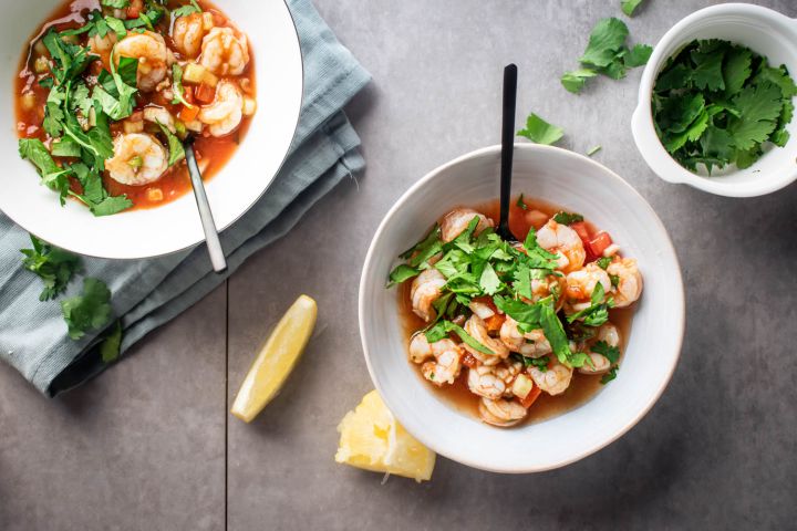 Cóctel de camarones with shrimp marinated in tomato and lime juice served with cilantro.