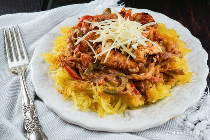 Cajun chicken spaghetti squash with peppers, chicken breast, a creamy tomato sauce, and spaghetti squash.