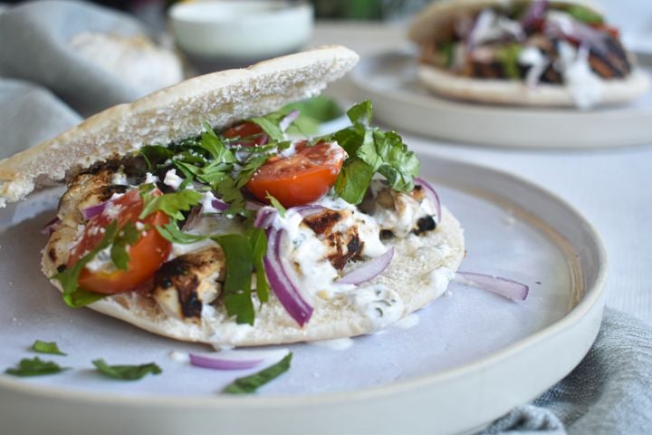Grilled chicken souvlaki marinated in lemon and garlic served in a pita with tzatziki, tomatoes, red onions, and parsley.