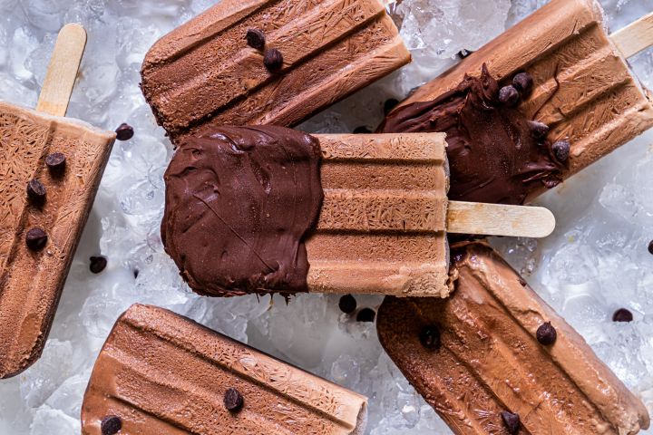 Healthy fudgesicles made with Greek yogurt frozen with chocolate chips.