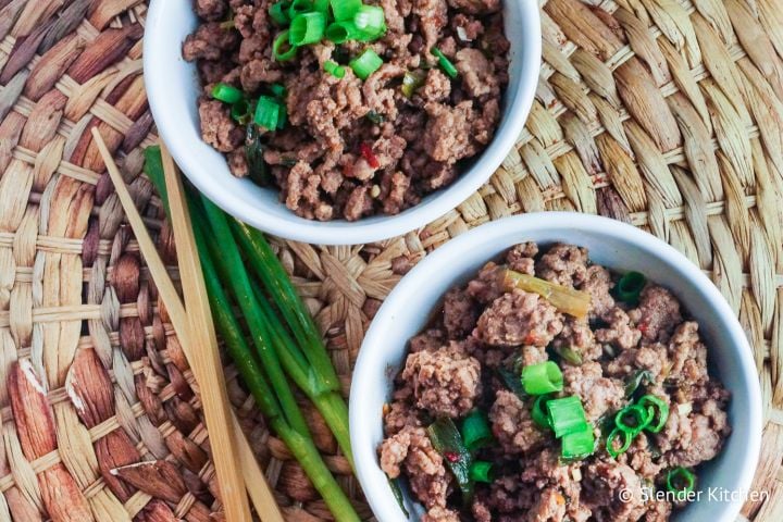 Mongolian ground beef with green onions and a sweet sauce in a bowl.
