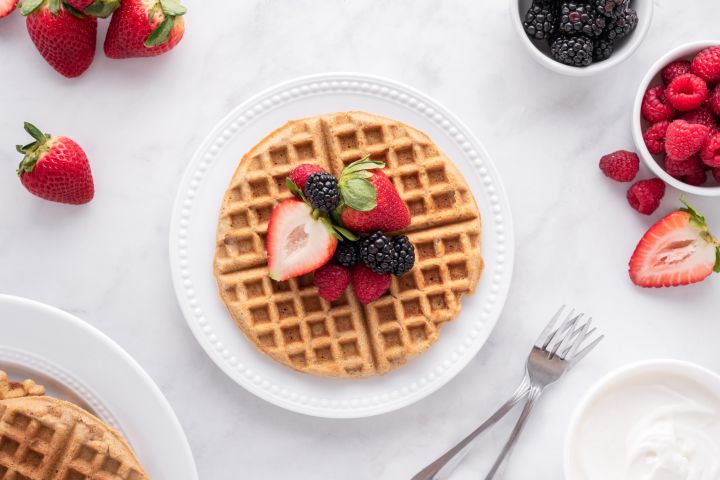 Low carb waffles made with almond and coconut flour on a plate with blueberries.