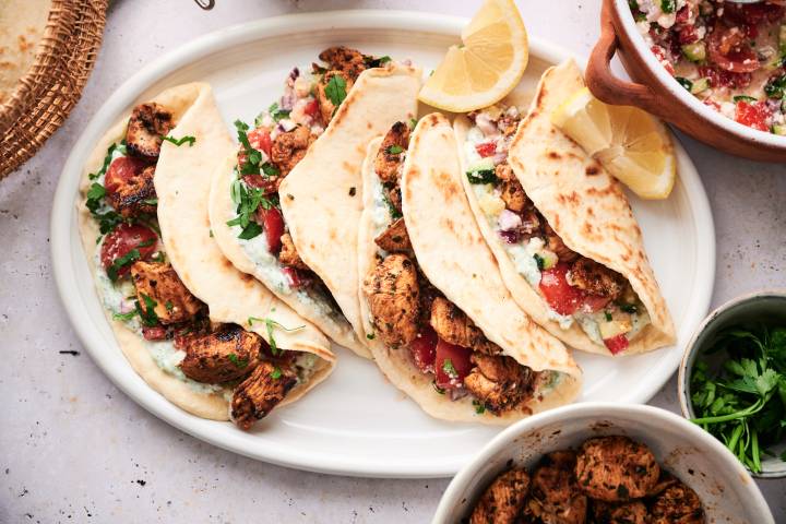 Mediterranean chicken tacos with cucumber tomato salsa, feta cheese, olives, and tzaztziki.