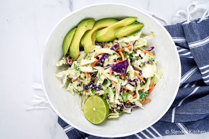Mexican coleslaw with lime Greek yogurt dressing with cabbage, carrots, cilantro, and avocado.