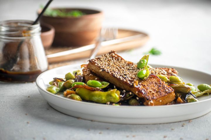 Pan fried tofu cooked in an Asian sauce with edamame and sesame seeds.