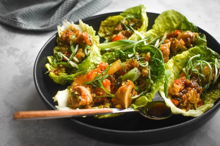 Vegetarian lettuce wraps with quinoa, mushrooms, red peppers, hoisin sauce, and butter lettuce. 