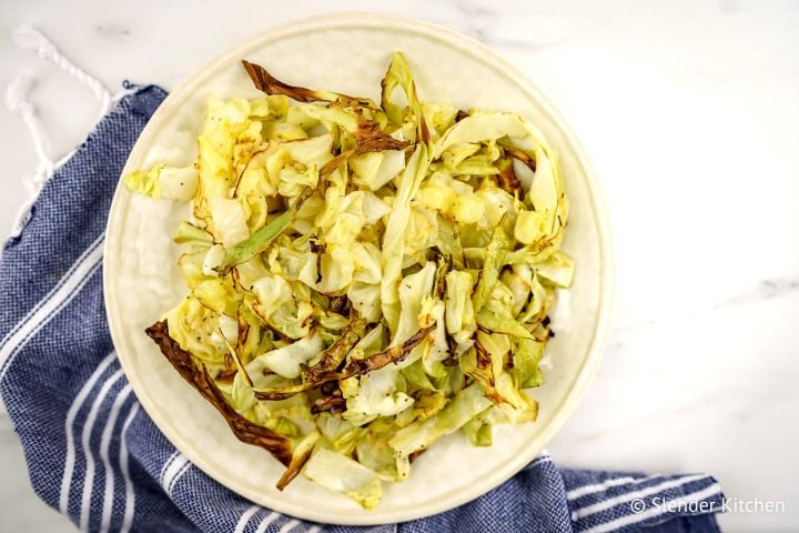 Roasted cabbage in pieces with browned edges on a plate.