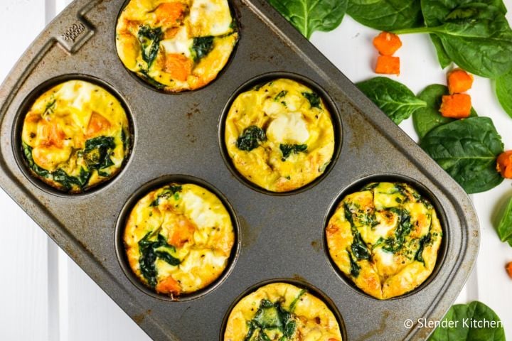 Sweet potato spinach egg muffin frittatas in a muffin tin with eggs, egg whites, spinach, and sweet potatoes.