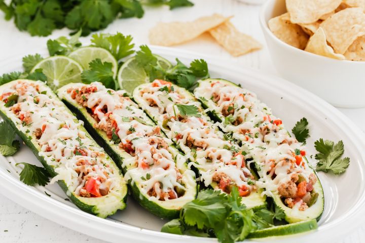 Zucchini taco boats with ground turkey, salsa, and melted cheese.