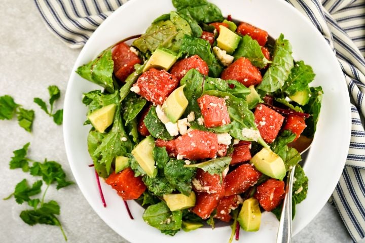 Watermelon avocado salad with cilantro and onions in a honey lime dressing.