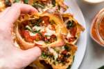 Lasagna muffins with sauteed vegetables, marinara sauce, and melted cheese cooked in a wonton wrapper.