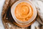 Creamy pumpkin smoothie with oatmeal, pumpkin puree, yogurt, and pumpkin pie spice in a glass with a copper straw.