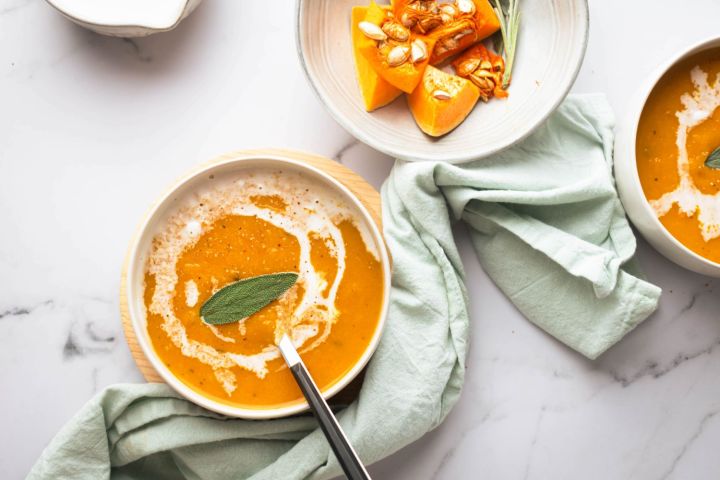Whole30 butternut squash soup with sage and a swirl of coconut milk.