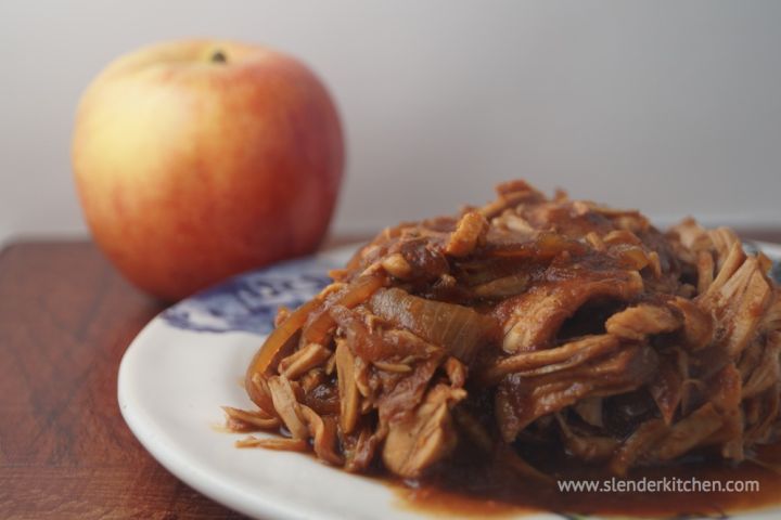 Slow cooker barbecue turkey breast with apples, onions, and barbecue sauce on a plate. 