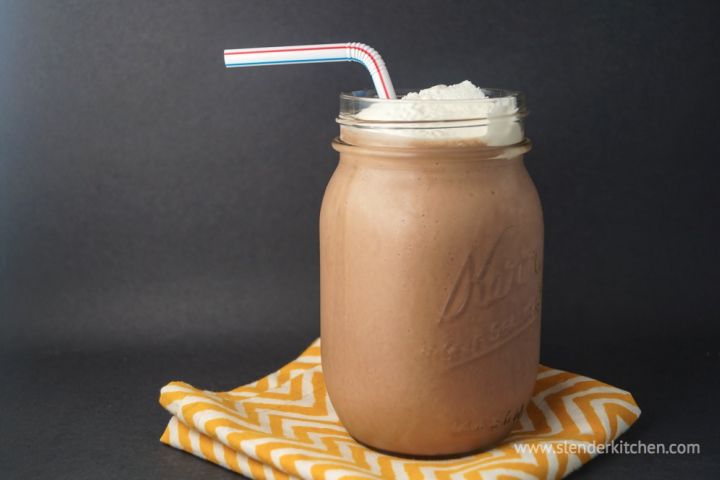 Chocolate breakfast shake with tofu, almond milk, and bananas in a mason jar with whipped cream.