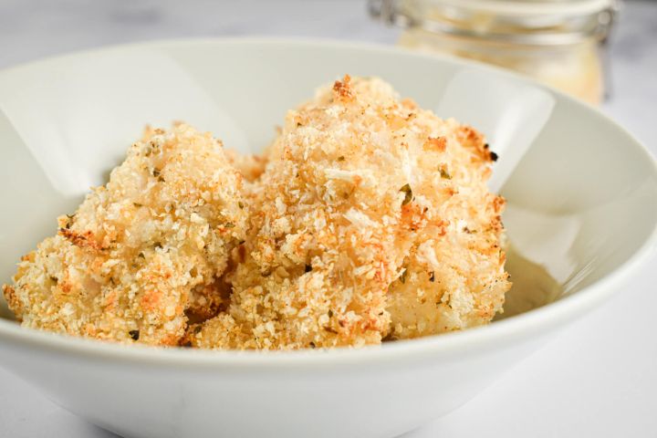 Baked Parmesan Fish Sticks in a bowl with a crispy panko and Parmesan crust.