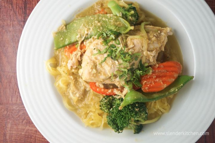 Slow cooker chicken curry with vegetables in a coconut milk broth in a bowl.