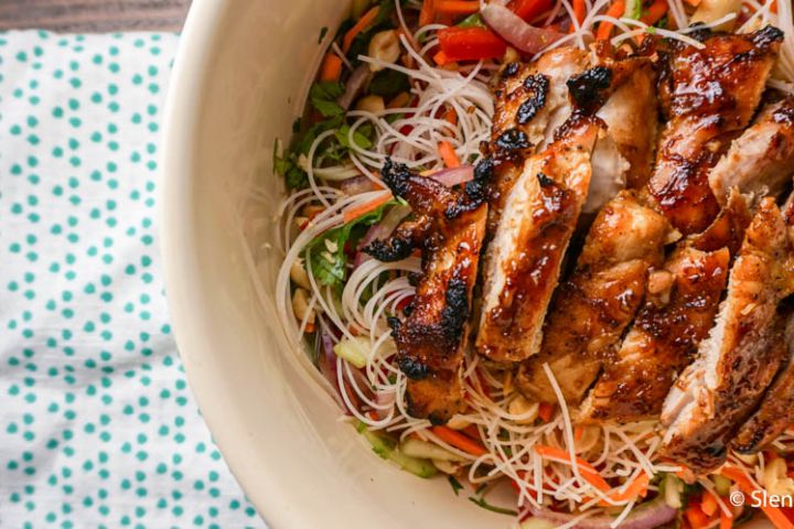 Asian noodle salad with vegetables and broiled hoisin chicken on top.