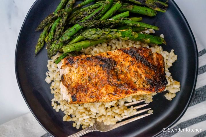 Cajun salmon on a bed of quinoa with asparagus.