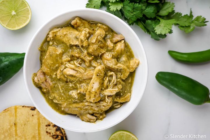 Authentic chile verde made with chicken in a green salsa in a bowl with cilantro.