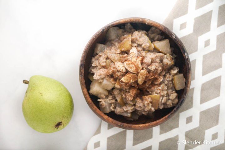 Cinnamon pear oatmeal in a bowl with diced pears, cinnamon, and old fashioned oats.