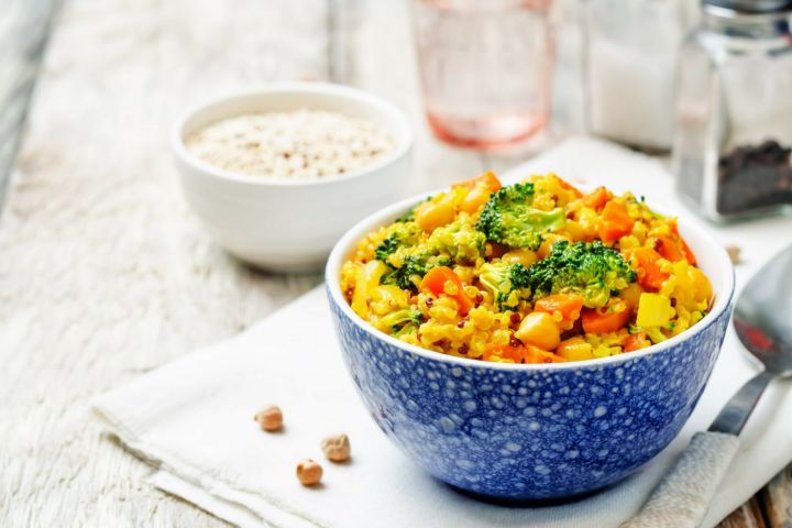 Coconut curry quinoa with broccoli and chickpeas in a bowl.
