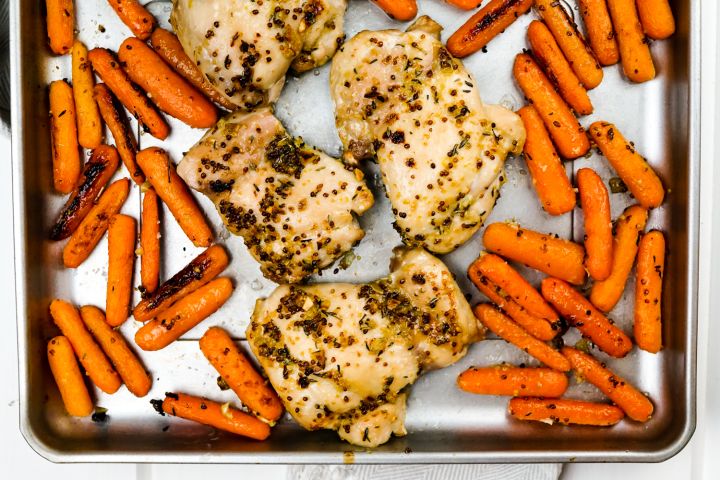 Honey mustard chicken with carrots on a sheet pan.