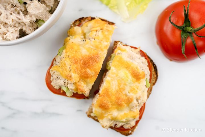 Healthy tuna melt served open faced with tomato slices and cheddar cheese.