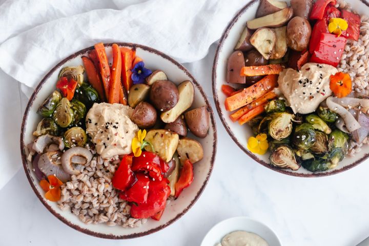 Honey balsamic roasted vegetable bowls with potatoes, peppers, onions, Brussels sprouts, carrots, and farro.