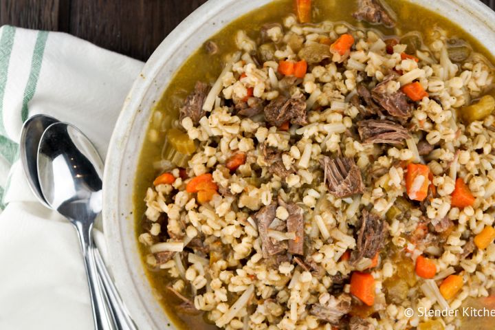 Instant Pot Beef and Barley Soup with carrots, celery, potatoes, and beef in a bowl.