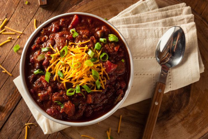 Low carb chili in a bowl with ground beef and cheese.