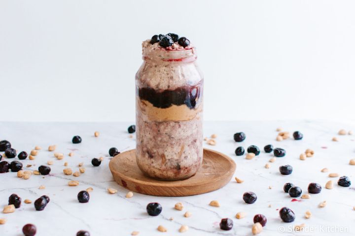 PBJ overnight oats in a mason jar with a layer of grape jelly and peanut butter. 
