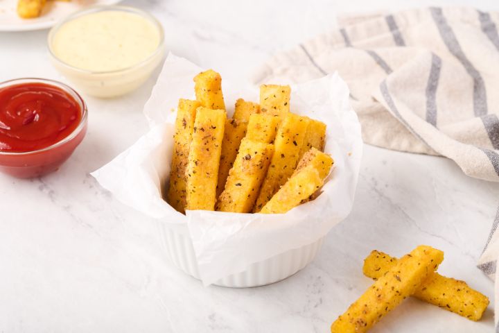 Polenta fries baked with Parmesan cheese and Italian seasoning served with ketchup on the side.