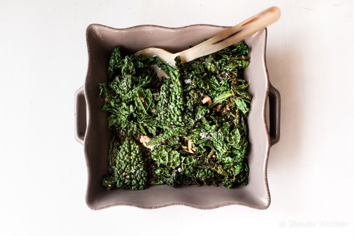 Sauteed kale with garlic, red wine vinegar, salt, and pepper in a ceramic dish.