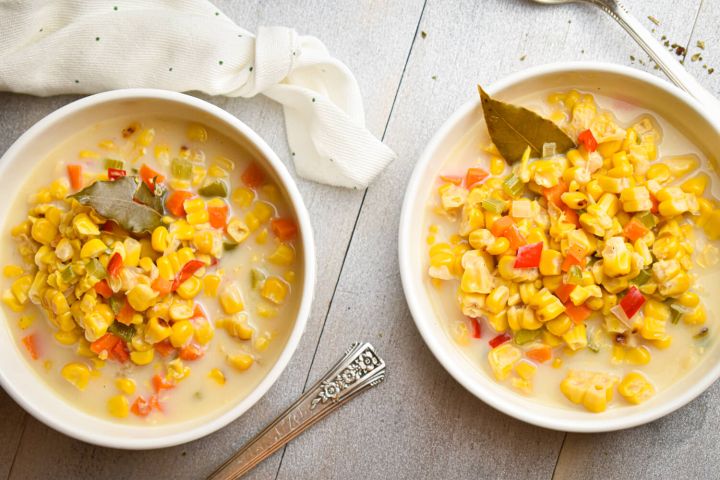 Slow cooker corn chowder with red peppers, carrots, celery, and poblano peppers in a creamy broth.