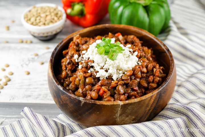 Slow cooker lentil sloppy joes with cheese in a wooden bowl.