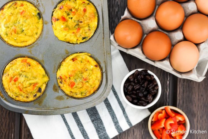 Black bean egg muffins in a muffin tin with eggs, black beans, and red pepper on the side. 