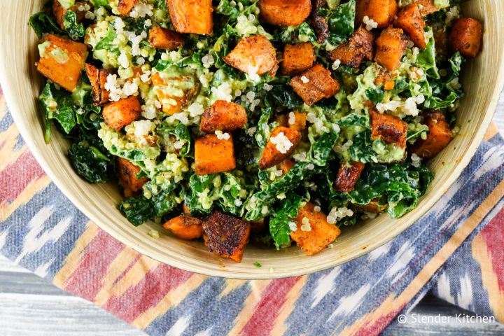 Southwestern sweet potato, kale, and quinoa salad in a bowl with a creamy avocado and lime dressing. 