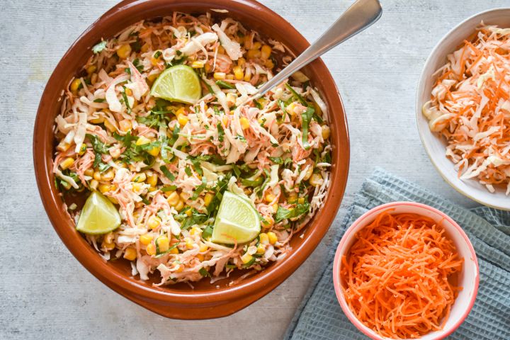 Spicy cabbage slaw with corn and shredded carrots in a creamy lime dressing.