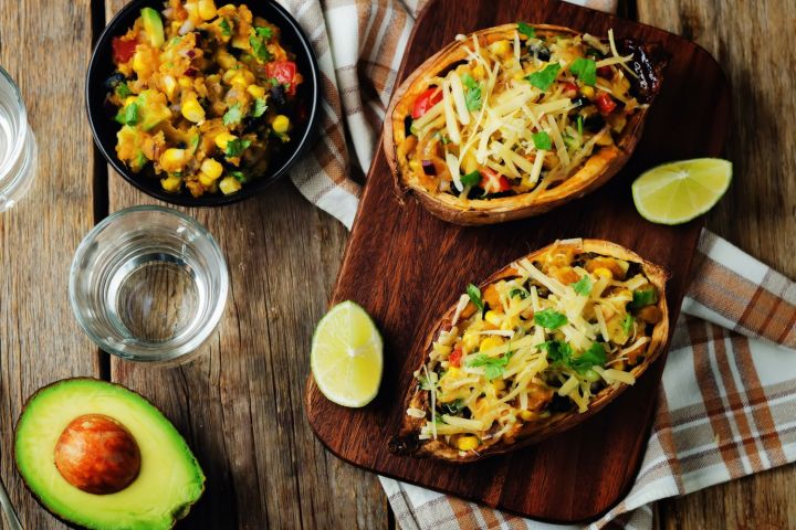 Stuffed sweet potatoes with Southwest ingredients including black beans, corn, diced tomatoes, green peppers, and cheese.