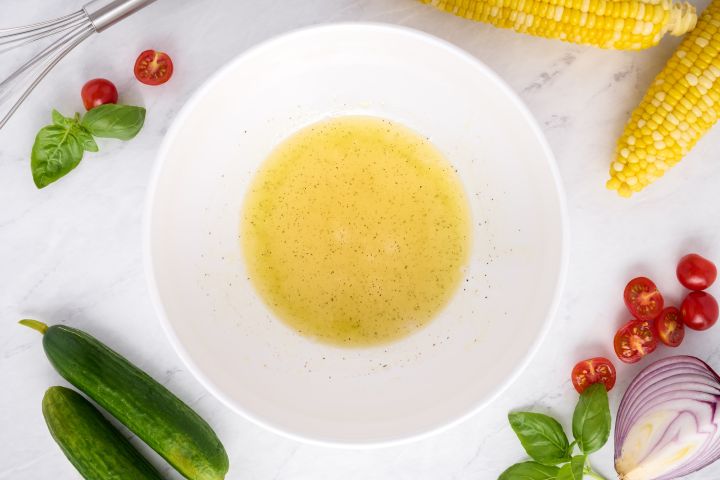 Apple cider vinegar and olive oil in a bowl for dressing.