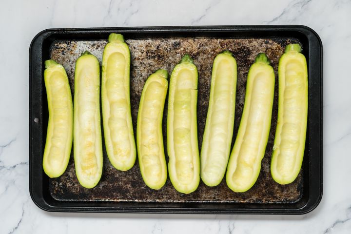 Zucchini boats on a baking sheet.