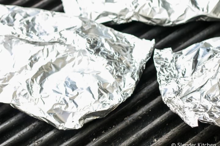 Grilled potato packets sealed and on the grill. 