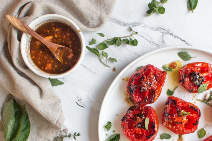 Grilled tomatoes with a tomato balsamic vinaigrette and fresh basil.