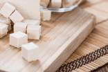Diced tofu on a wood cutting board